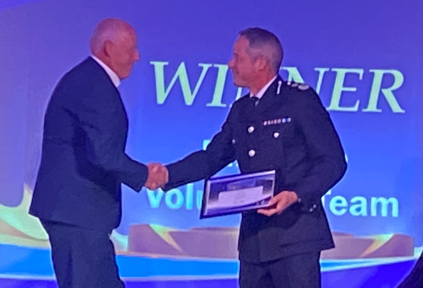 The image shows the Chief Constable of Lincolnshire Police presenting the award to RoSPA Advanced Drivers and Riders Lincolnshire and BikeSafe tutor Andy McNeil.